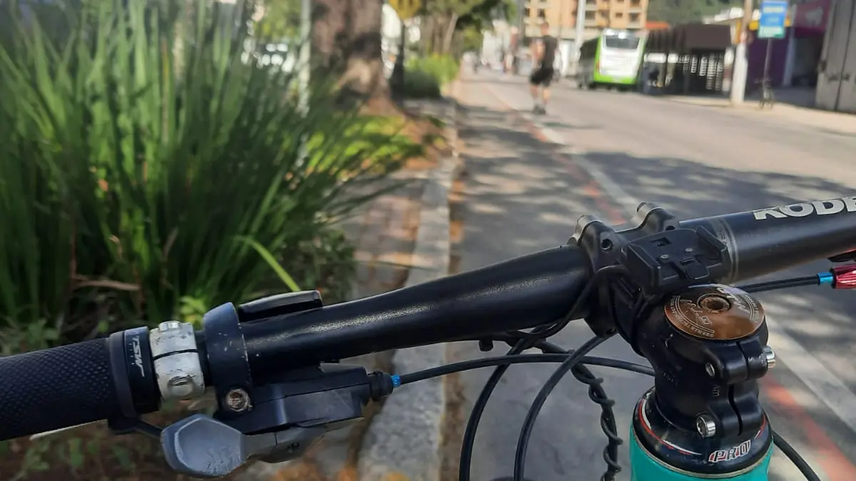 Bicicleta estacionada ao lado de uma ciclofaixa em Teresópolis, ilustrando o debate sobre mobilidade sustentável e infraestrutura para ciclistas na Região Serrana.